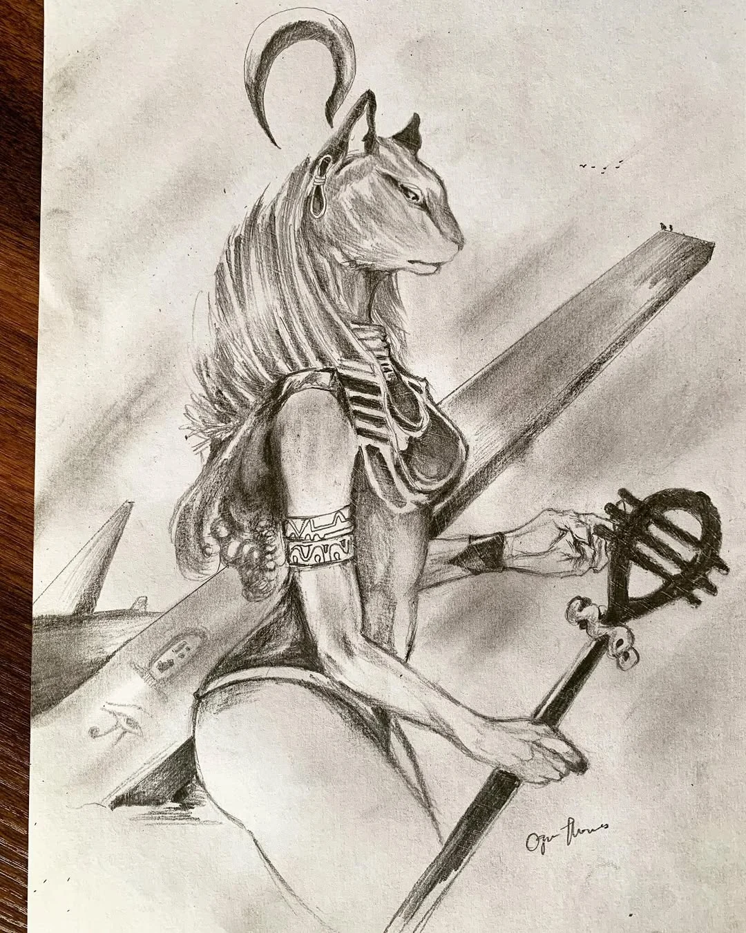 Pencil figure holding a staff beside an animal motif