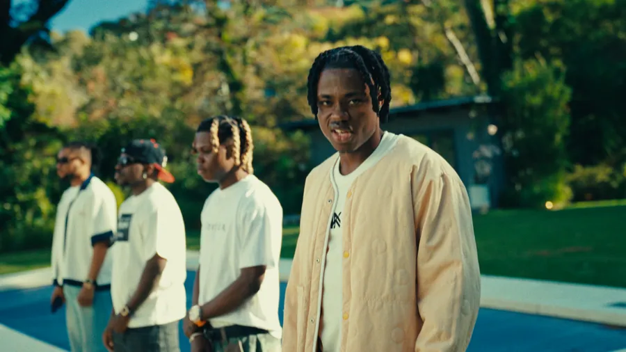 Vorstar performing with cast in a cinematic outdoor scene
